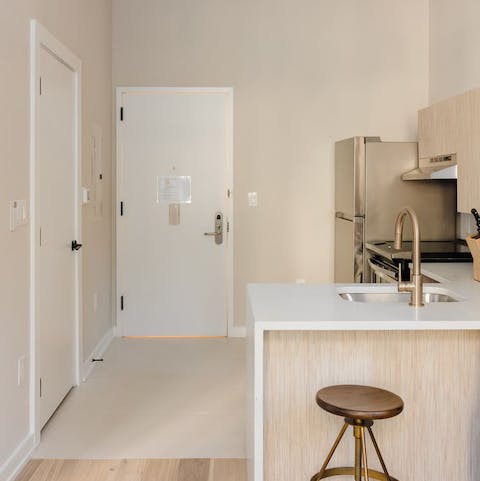 Perch at the sleek breakfast bar with a coffee