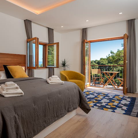Enjoy light-filled bedrooms with private balconies upstairs
