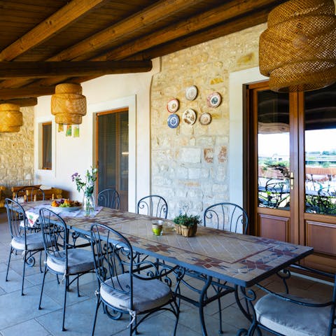 Gather around the dining table for a lunch spread of salads, fresh breads, olives, and cheese