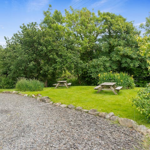 Relax by the neighbouring stream that runs through the pretty garden