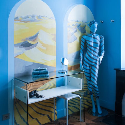 Be fooled by this funky blue corner with a painted mannequin sculpture