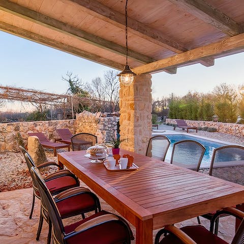 Set up for rustic group meals beneath the wooden roof