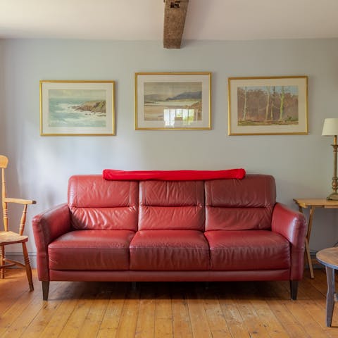 Sink into the red leather couch at the end of a long walk through the countryside