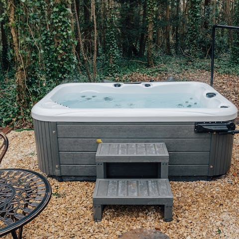 Relax in the hot tub with its pretty sylvan setting 
