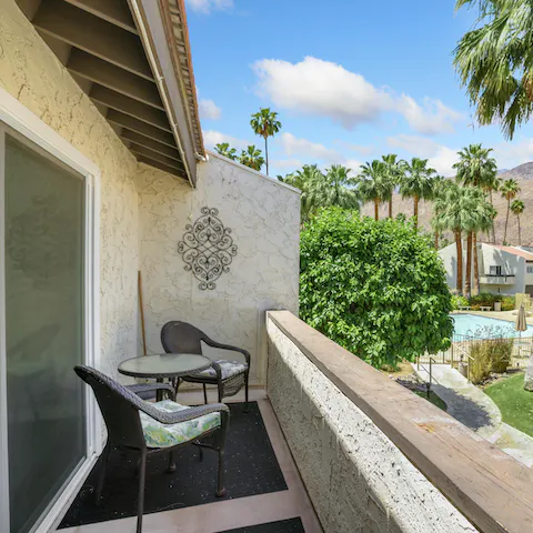 Enjoy your morning coffee on the balcony overlooking the palm trees