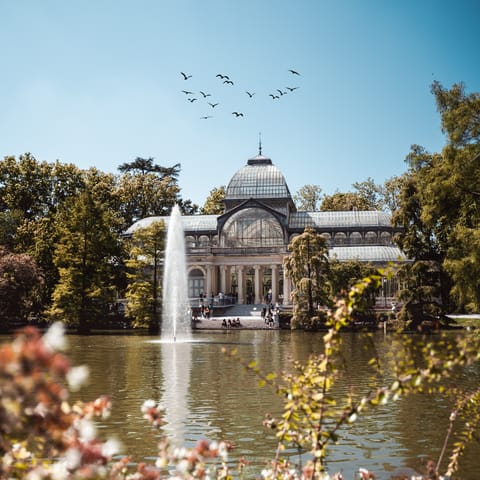 Reach El Retiro Park in twenty minutes on public transit and wander about the monuments, fountains and gardens