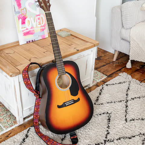 Play a few tunes on the home's guitar