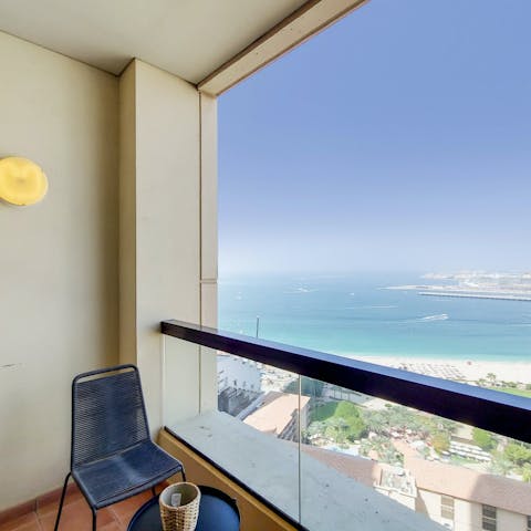 Head out to the balcony and gaze out at the impossibly blue sea