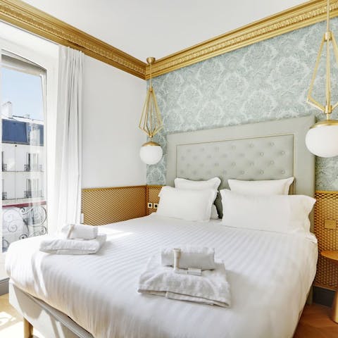 Wake up to 8th arrondissement views from the main bedroom's Juliet balcony