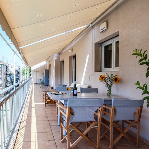 Share a glass of Assyrtiko wine on your private balcony at the golden hour