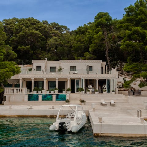 Arrive by boat at this dreamy island villa