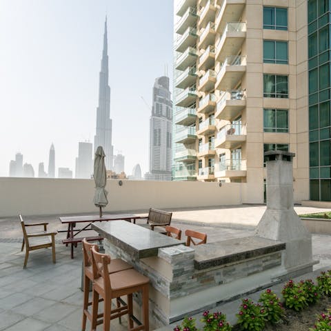 Head up to the communal rooftop terrace for an alfresco barbecue with Burj Khalifa views