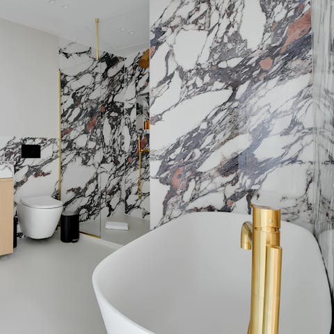 Relax in the freestanding bathtub in the marble bathroom