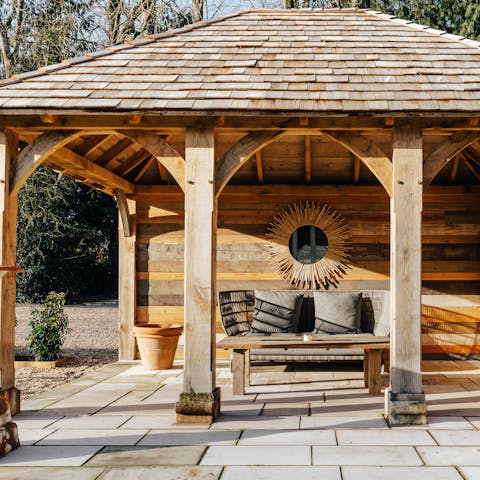 Enjoy the evening sun beneath the wooden gazebo