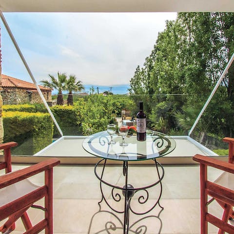 Set up on the first-floor balcony and admire the palm-fringed view