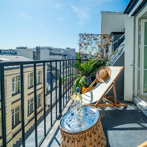 Admire the view of Paris' rooftops from the private balcony