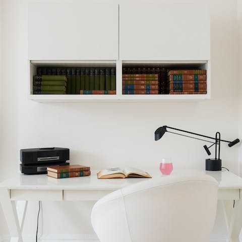 A stack of books above the desk