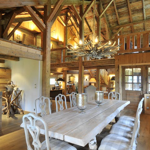 Gather for big meals at the rustic table beneath the Alpine chandelier