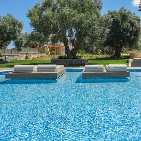 Soak up the Cretan sunshine from the floating loungers 