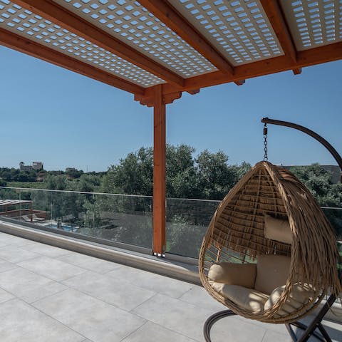 Take in scenic views of the surrounding greenery from the terrace