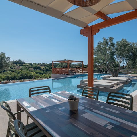 Serve up some Greek culinary delights at the poolside dining area 