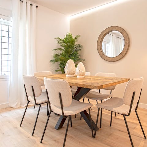 Gather around the chic dining table for relaxed dinners, drinks, and card games at home