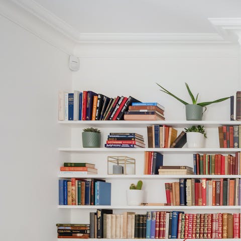 Dive into the book collection and spend a lazy morning reading on the sofa