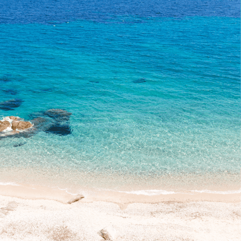 Soak up the sun as you sink your feet into the sand at Glyfadi beach, just 900m from the villa