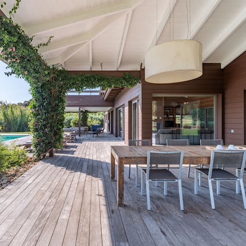 Dine on the terrace with a view framed by ivy