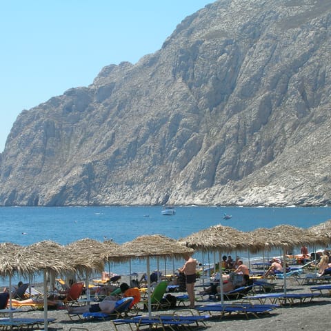 Sunbathe on Caldera Beach, just a six-minute walk away from the villa