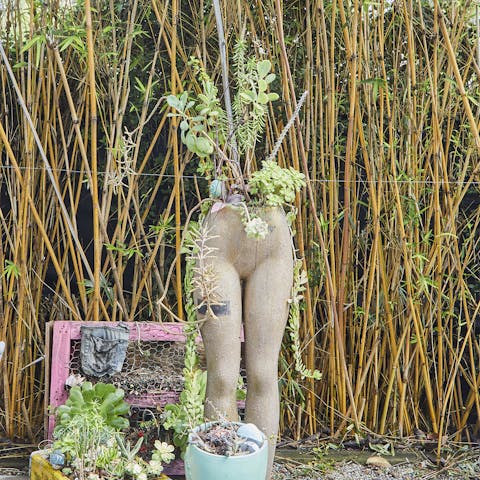 A mannequin planter out back