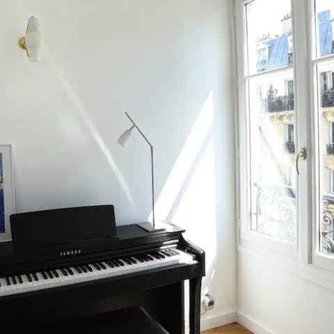 Play some romantic tunes while gazing out at the Parisian cityscape