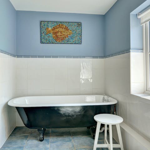 Have a soak in the roll-top bath after a long walk on the beach