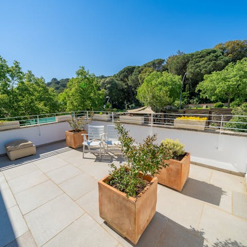 Enjoy a moment's peace on the home's rooftop terrace surrounded by treetops