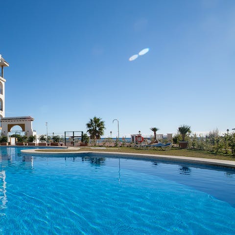 Spend relaxing days lounging by the communal pool or walk to the beach