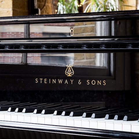 Tinkle the ivories at the home's own stunning Steinway grand piano
