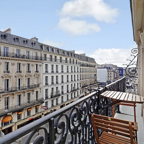 Watch the hustle and bustle of Paris from the charming balcony