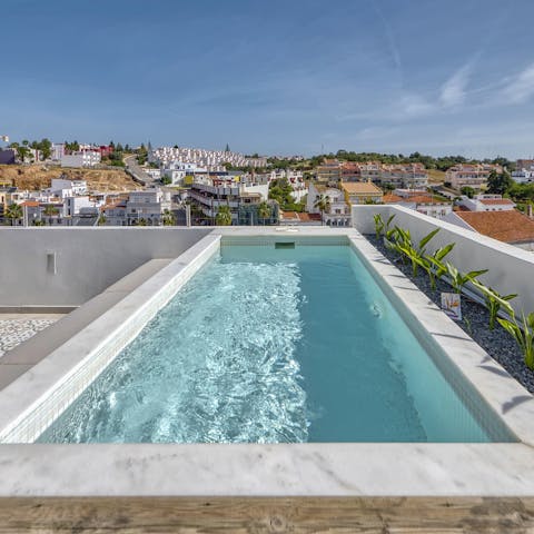 Enjoy a dip in the pool with a view of Ferragudo rooftops as far as the eye can see