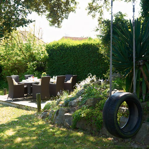 Enjoy sundowners in the garden as little ones play on the tyre swing 