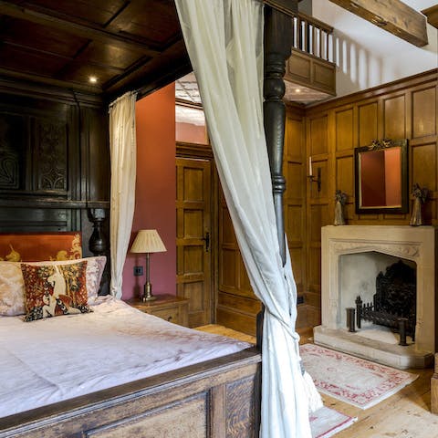 A medieval style bedroom with a four poster bed