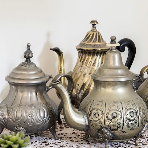 A collection of brass teapots