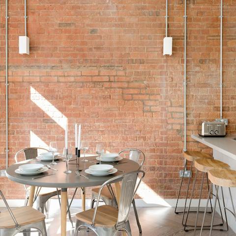 Work from home at the dining table in front of the exposed brick walls