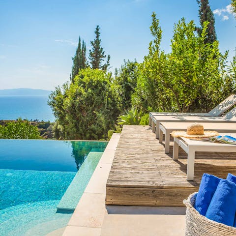 Get comfy by the pool and enjoy the sunshine and the stunning sea views