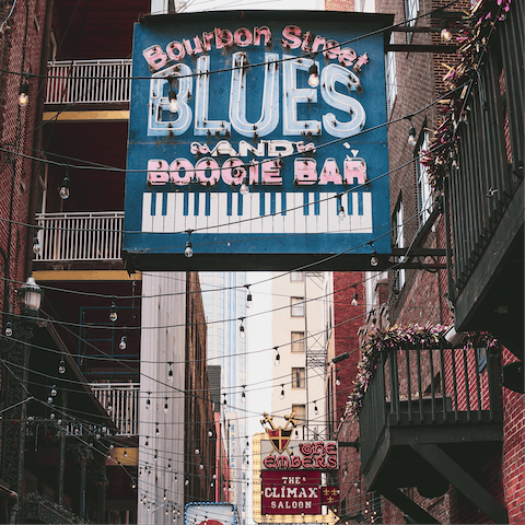 Grab a drink on Bourbon Street, an eight-minute walk away