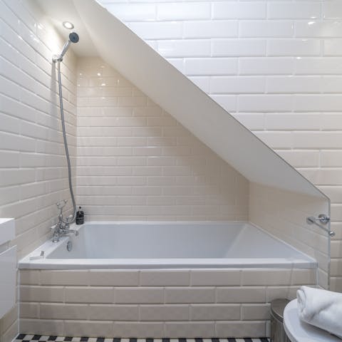 Relax in one of the home's bathtubs after a busy day in the city