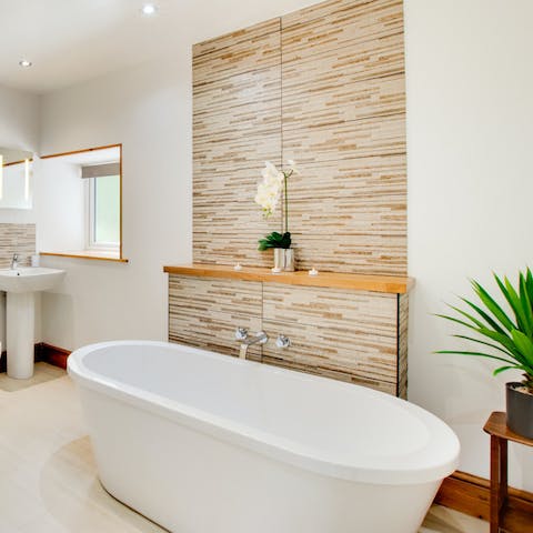 Lock the door and treat yourself to an uninterrupted soak in the elegant freestanding tub