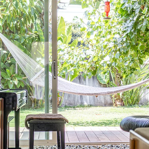 Swing on the hammock amidst the garden's greenery