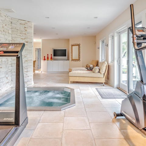 Relax in the indoor hot tub after a session at the home gym