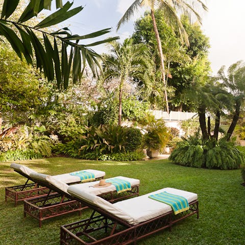 Lounge amid the lush botanica of the verdant, enclosed garden