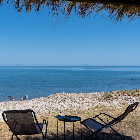 Take in the beautiful views of the big blue while you relax on your private pebble beach